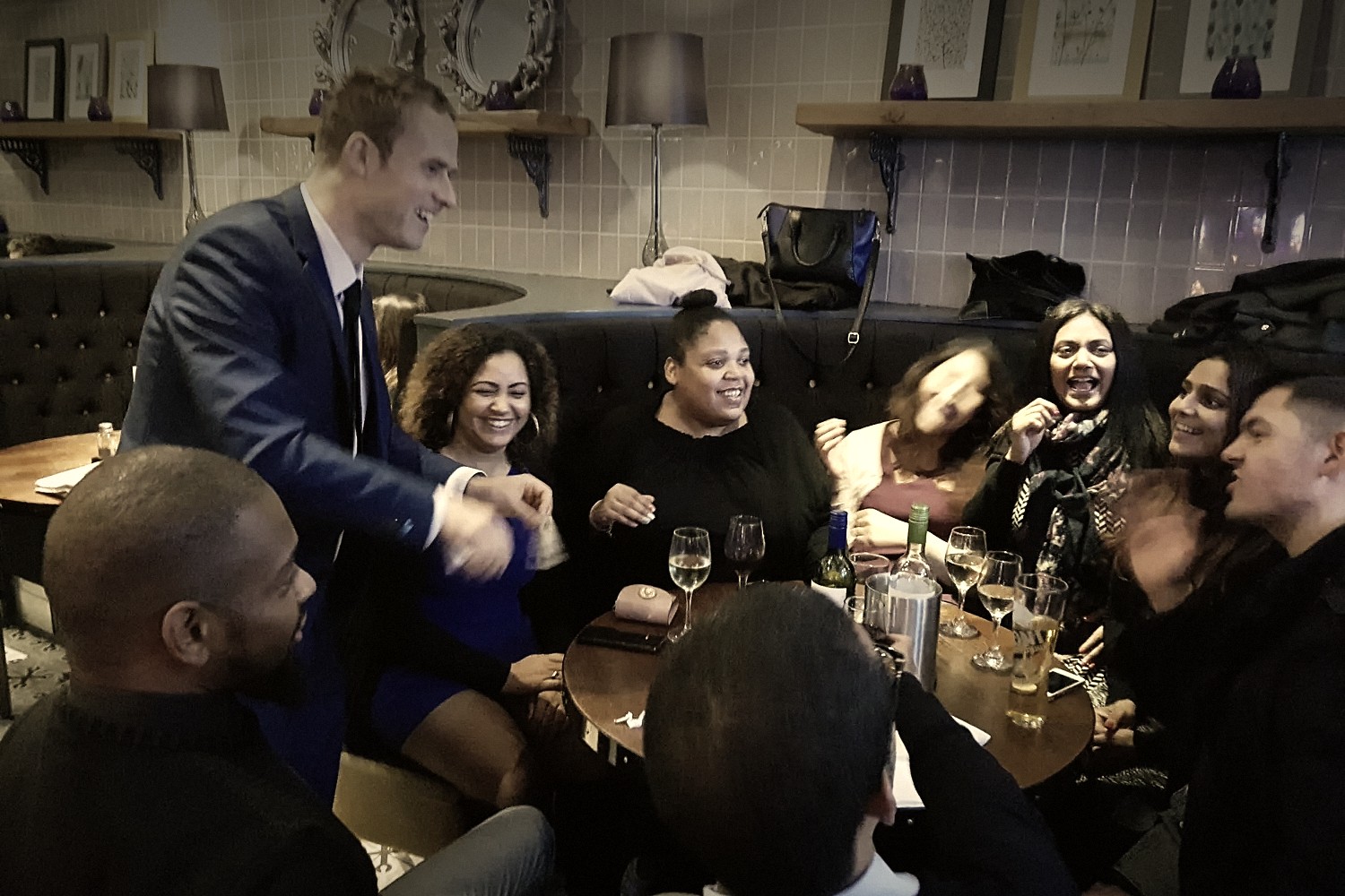 Daniel performing close-up magic for guests in a restaurant